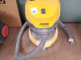 a yellow vacuum cleaner sitting on the floor next to a box