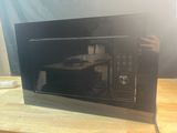 a microwave that is sitting on a table in a room
