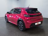 the rear end of a red car parked in a garage