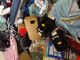 a pile of clothes and other items in a suitcase