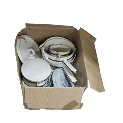 a cardboard box with a bunch of dishes and pans in it