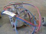 a machine that is sitting on the ground next to a hose