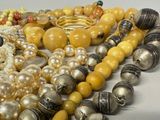 a lot of beads and rings on a table