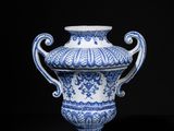 blue and white vase with handles on a black background