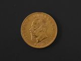 a close up of a gold coin on a black surface