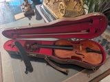 a violin and a violin case sitting on a table