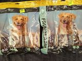 two bags of dog food sitting on top of a bed
