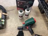a box of glue, a glue gun, and a pair of gloves on the floor