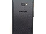 the back of a black samsung galaxy s4 with a camera attached to it