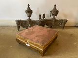 a small ottoman sitting on the floor in front of a bed