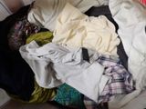 a pile of clothes in a suitcase on the floor