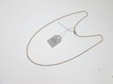 silver plated necklace with a tag attached to it on a white surface