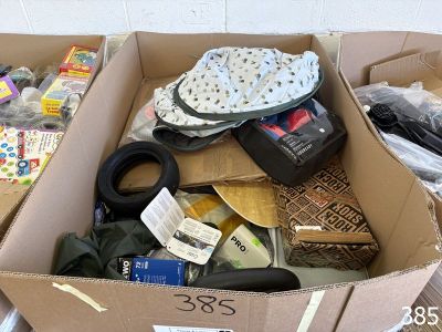 a cardboard box filled with assorted items on the floor
