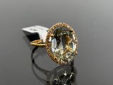 an image of a yellow gold ring with a green and white diamond