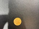 a picture of a gold coin sitting on a table