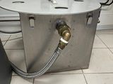 a metal box with a hose attached to it on the floor