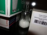 a salt and pepper shaker next to a box of salt and pepper shakers