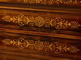 a close up of a chest of drawers with a clock on top