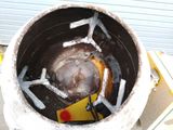 a large metal pot with a rusted metal lid on it