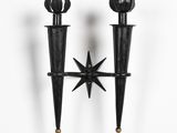 pair of black metal candlesticks with starbursts on them