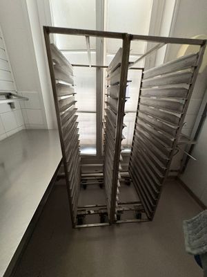 an image of a kitchen with a bunch of trays of food in it