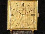 une image d'une montre en or avec des chiffres romains sur le cadran