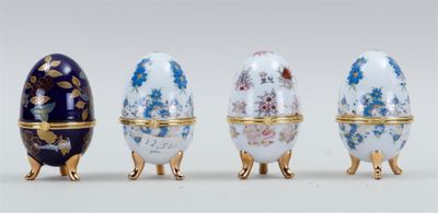 four different types of decorated eggs are lined up in a row