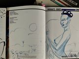a drawing book with a picture of a woman in a dress