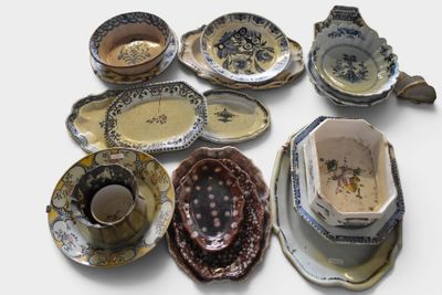 a lot of different plates and cups on the table
