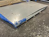 a pile of pallets sitting on top of a floor in a warehouse
