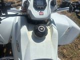 a motorcycle that is parked on the grass in the field