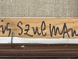 a wooden sign on the side of a building