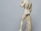 statue of a man holding a fish in his hands