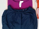 two shirts and a pair of shorts are sitting on a table