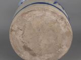 an old blue and white vase with a blue stripe around the bottom