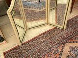 a mirror that is sitting on the floor next to a rug