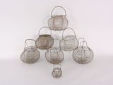 several wire baskets are stacked on top of each other on a white surface