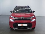 the red citrole is parked in a room with a white wall