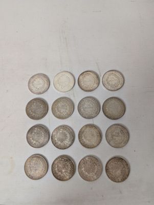 several different types of coins are arranged on a white surface