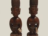 pair of wooden figurines of a man and a woman