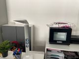 a microwave sitting on top of a desk next to a printer