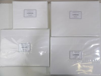 several white boxes are stacked on top of each other on a table