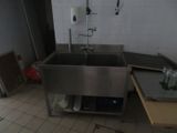 a stainless steel sink in the middle of a kitchen