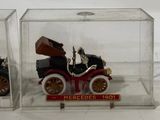 two small toy cars in a clear box