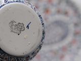 a close up of a vase with a blue and white design on it