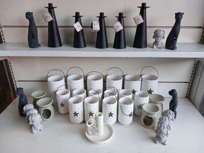 many cups and vases on a shelf in a room