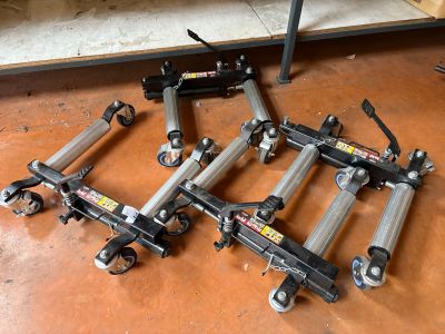 four different types of hydraulic jacks sitting on the floor