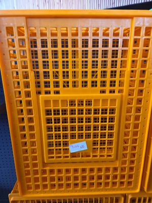 yellow plastic crates stacked on top of each other on a blue floor