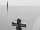 a close up of a white truck with a cobra on it ' s side