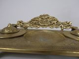 a gold plate with two candles on top of it